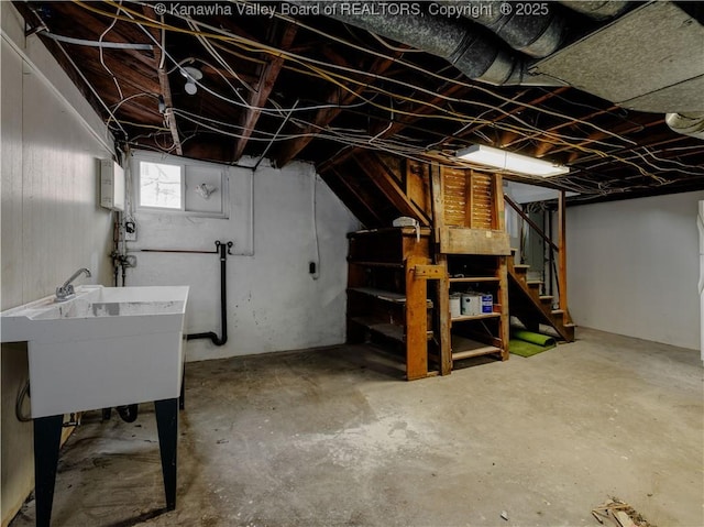 basement with a sink and stairs