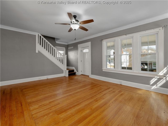 entrance foyer with crown molding, baseboards, stairs, and light wood-style floors