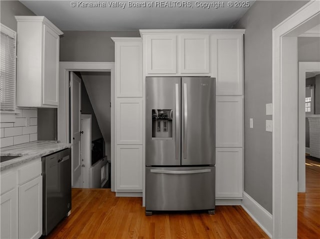 kitchen with dishwashing machine, white cabinets, light wood-style floors, and stainless steel refrigerator with ice dispenser