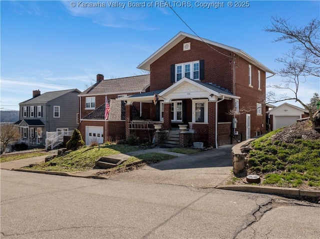 view of front of house featuring brick siding and a garage