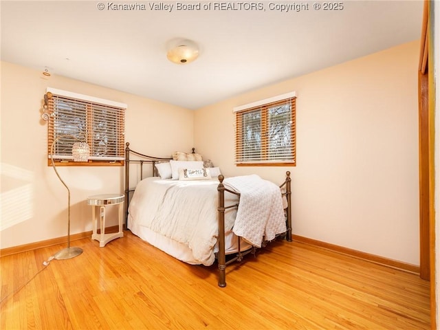 bedroom with baseboards and wood finished floors