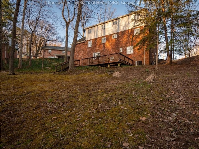 back of property featuring a wooden deck