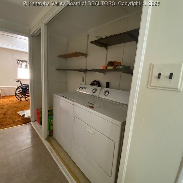 laundry room with laundry area, separate washer and dryer, and light floors