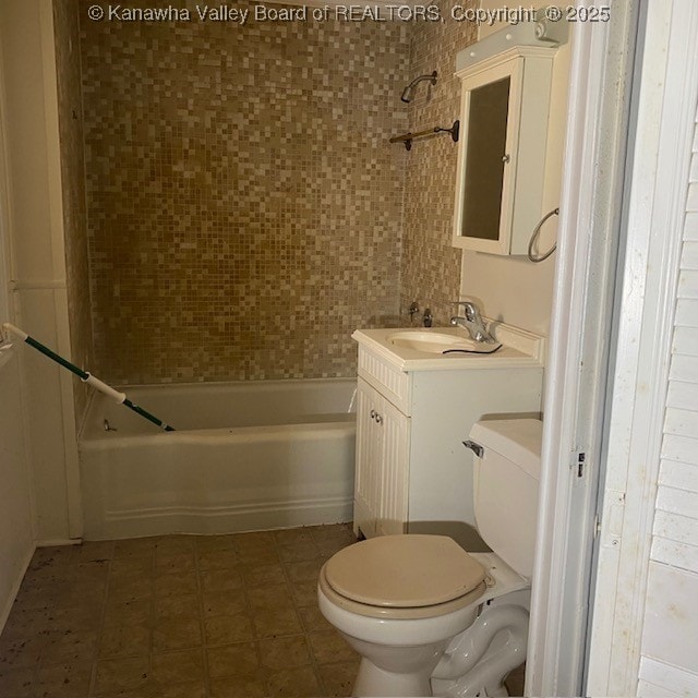 bathroom with shower / washtub combination, toilet, and vanity