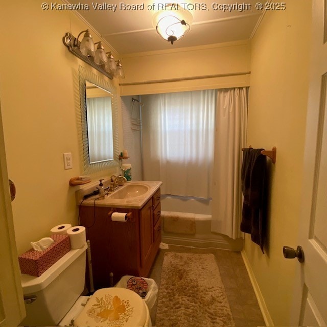 bathroom with baseboards, toilet, ornamental molding, bathtub / shower combination, and vanity