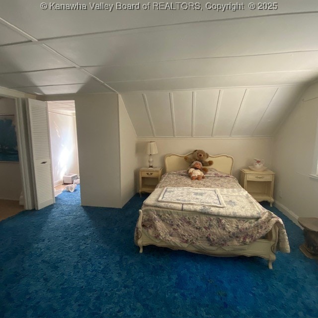 carpeted bedroom with vaulted ceiling