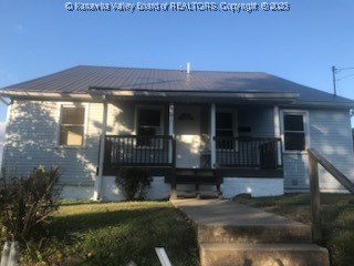 view of front of home with a front yard and covered porch