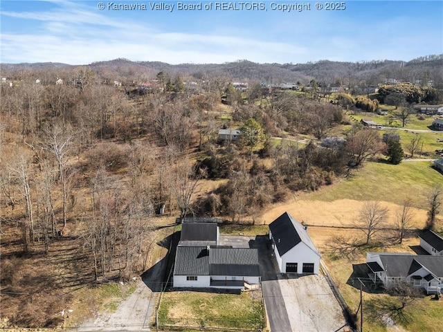 drone / aerial view featuring a wooded view