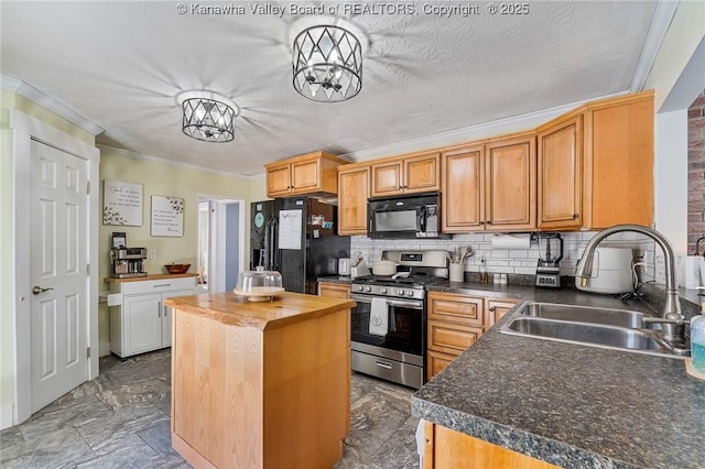 kitchen featuring a kitchen island, butcher block countertops, decorative backsplash, black appliances, and a sink