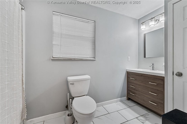 full bath with toilet, marble finish floor, a shower, baseboards, and vanity