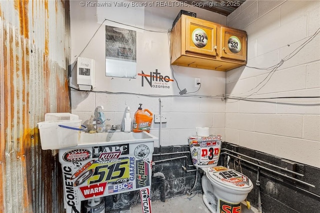 kitchen with concrete flooring and concrete block wall