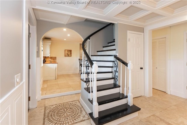 stairs featuring tile patterned floors, beamed ceiling, recessed lighting, arched walkways, and coffered ceiling