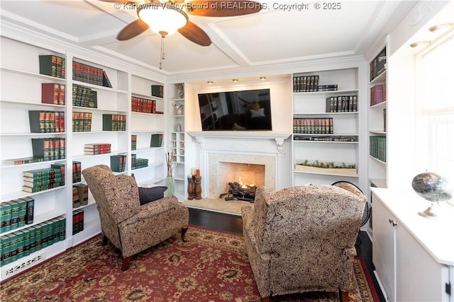 sitting room featuring a premium fireplace and a ceiling fan