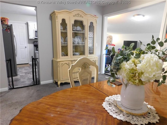 dining area with carpet flooring and baseboards