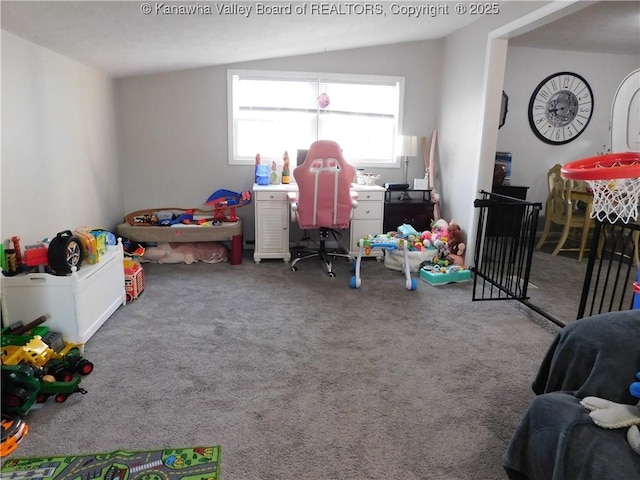 recreation room featuring vaulted ceiling and carpet flooring