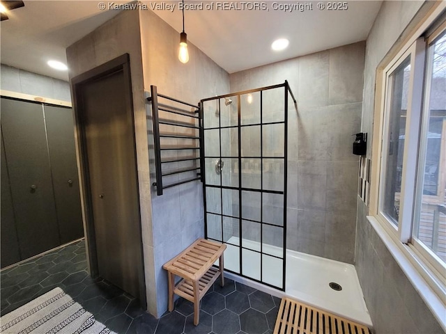 full bath with walk in shower and tile patterned flooring