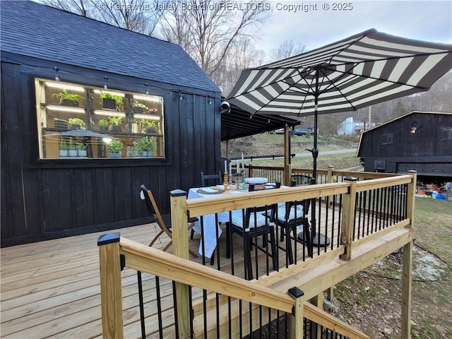 deck with outdoor dining area