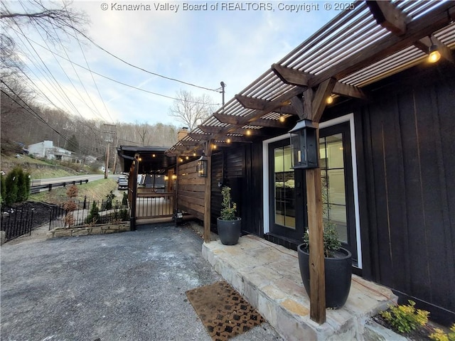 exterior space featuring a patio area, a pergola, and fence