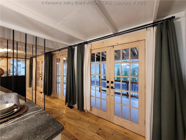 doorway with french doors and hardwood / wood-style floors