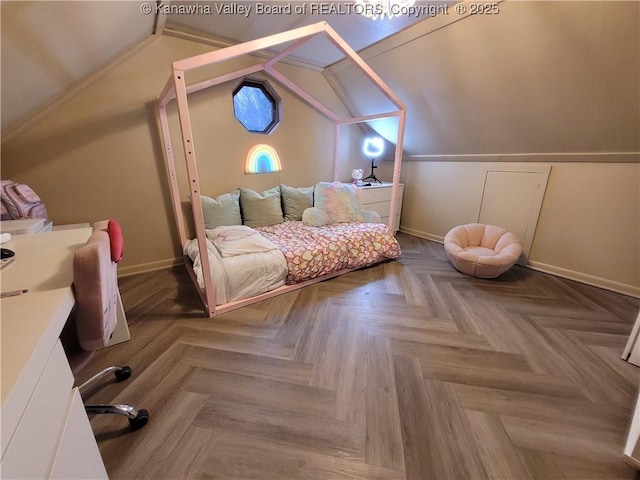 bedroom with baseboards and lofted ceiling