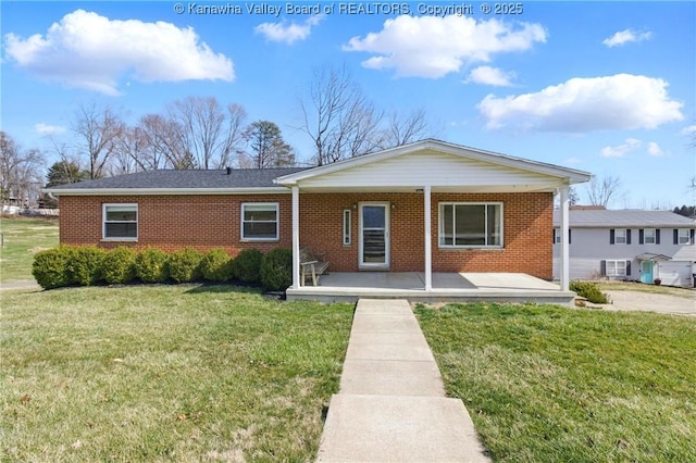 view of front of property featuring brick siding, a porch, and a front lawn