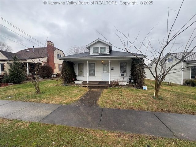 bungalow-style home featuring covered porch and a front yard