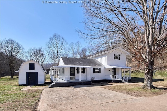 view of front of property with a storage shed, a porch, an outbuilding, and a front yard