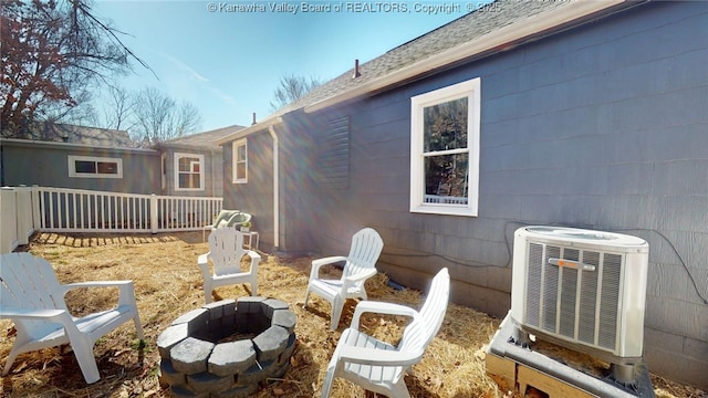 exterior space featuring a fire pit and central AC