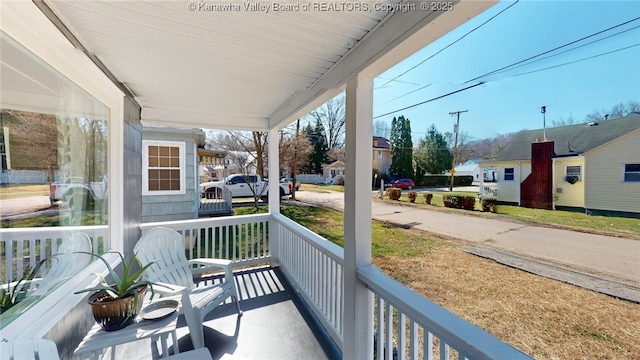 balcony featuring a residential view and covered porch