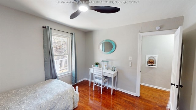 bedroom featuring wood finished floors, baseboards, and ceiling fan