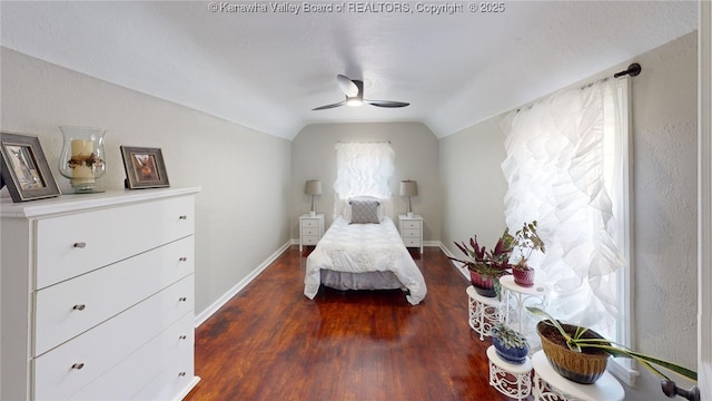 bedroom featuring ceiling fan, baseboards, lofted ceiling, and dark wood-style flooring