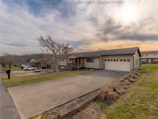 single story home with concrete driveway, a yard, and an attached garage