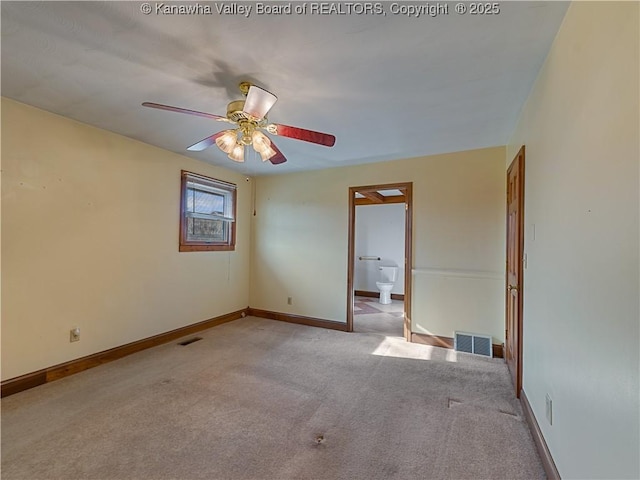 spare room with visible vents, baseboards, and ceiling fan