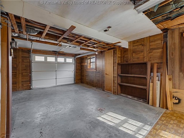 garage featuring wood walls