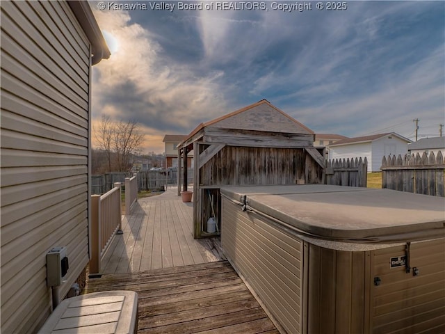 wooden terrace with fence and a hot tub