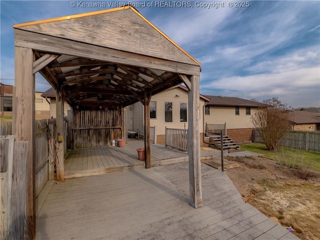 view of patio with a deck and fence