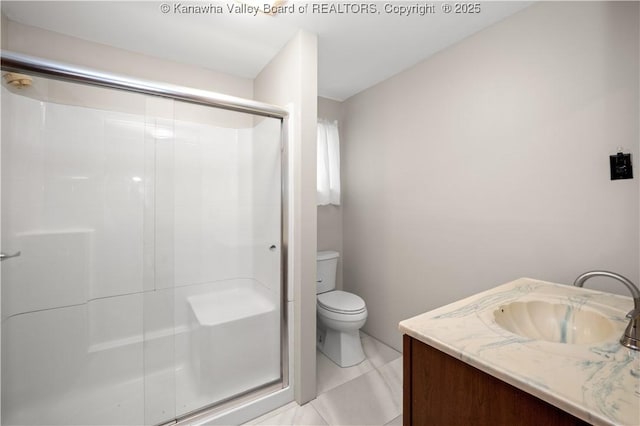 bathroom featuring a shower stall, toilet, and vanity