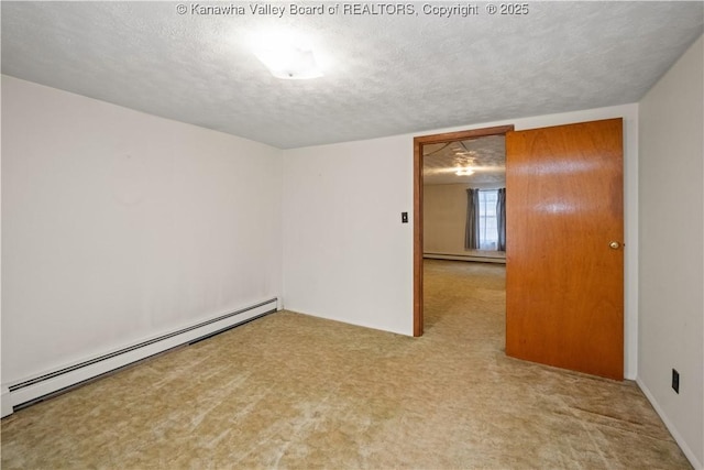 carpeted empty room featuring baseboard heating, a textured ceiling, and a baseboard radiator