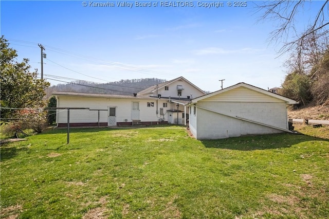 back of house with a yard and fence
