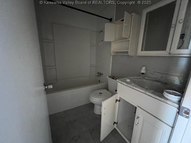 bathroom featuring vanity, toilet, and shower / washtub combination