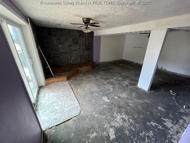 interior space featuring a textured ceiling and a ceiling fan