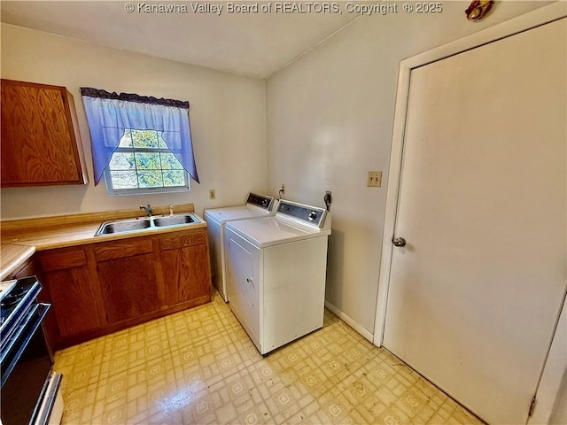 laundry room featuring a sink, light floors, and washer and clothes dryer