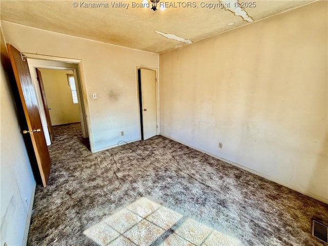 unfurnished bedroom with carpet flooring and visible vents