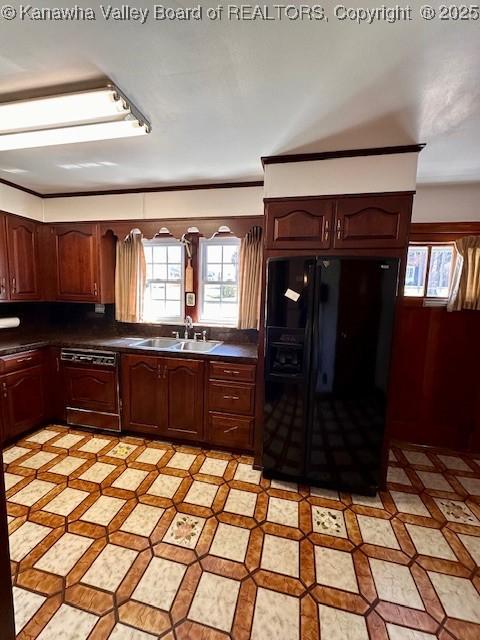 kitchen featuring a sink, paneled dishwasher, dark countertops, light floors, and black refrigerator with ice dispenser