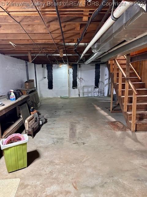 unfinished basement featuring stairs