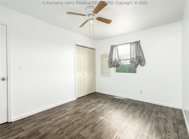 unfurnished room with wood finished floors, baseboards, and ceiling fan