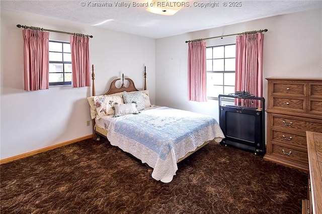 carpeted bedroom featuring baseboards and a textured ceiling