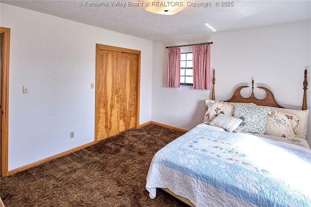 carpeted bedroom with a closet, a textured ceiling, and baseboards