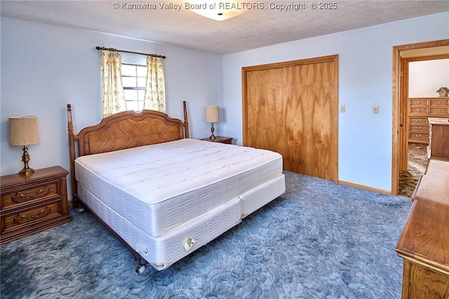 carpeted bedroom featuring a closet, a textured ceiling, and baseboards