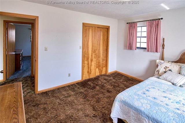 carpeted bedroom featuring baseboards, a closet, and a textured ceiling